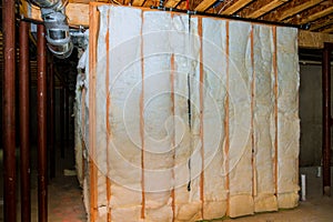 Insulation of basement with fiberglass cold barrier and insulation material