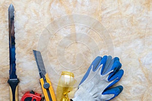 Mineral rockwool lying on attic floor inside house under construction