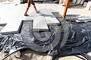 Insulation of the foundation with polystyrene foam plates. Preparation for installation work using thermal insulation materials.
