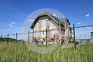 Insulation of the house with facade bricks, construction of a new house and scaffolding near the walls