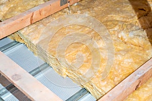 insulation of the house under the roof with the help of glass wool