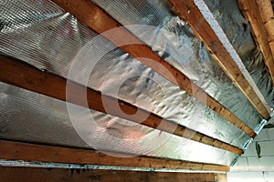 Insulation of the roof of the house on the inside with the use of a wrapper film and fixing boards