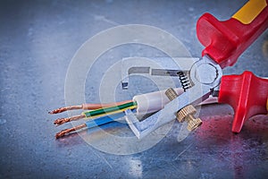 Insulation strippers electric wires on metallic background horiz