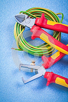 Insulation strippers electrical cable nippers on blue background