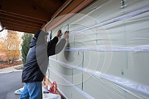 insulation strips being installed on garage door panel