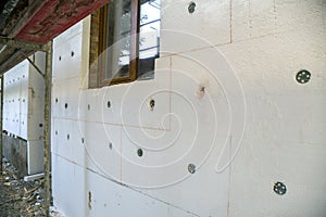 Insulation work of house walls with styrofoam sheets