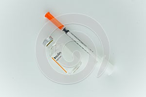 Insulin bottle and medical needle.