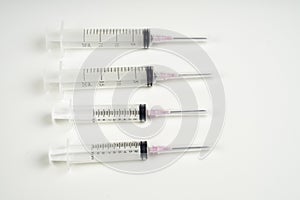 Insulin and large syringe, white background
