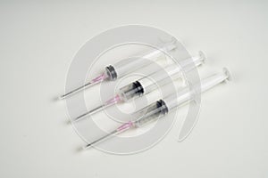 Insulin and large syringe, white background
