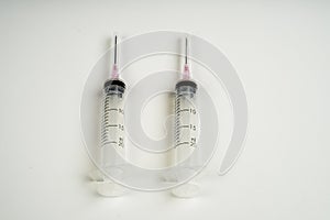 Insulin and large syringe, white background