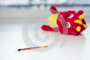 Insulin syringe on child hospital table.