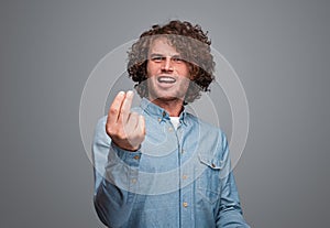 Insulted man showing money gesture photo