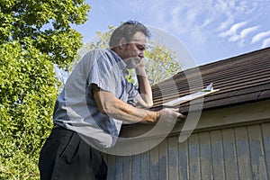 Insurance Adjuster Checking Roof For Hail Damage