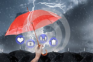 Insurance agent covering illustrations with umbrella during storm