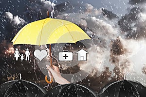 Insurance agent covering illustrations with umbrella during storm
