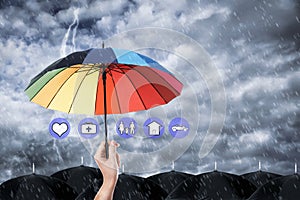 Insurance agent covering with umbrella during storm