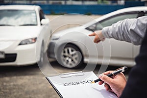 Insurance Agent examine Damaged Car and filing Report Claim Form