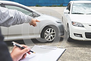 Insurance Agent examine Damaged Car and filing Report Claim Form