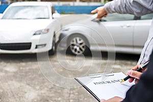 Insurance Agent examine Damaged Car and filing Report Claim Form