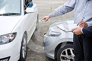 Insurance Agent examine Damaged Car and filing Report Claim Form