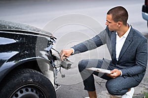 Insurance Agent Examining Car