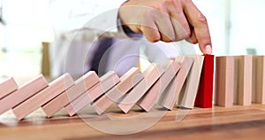 Insurance agent hand stopping falling wooden blocks closeup 4k movie