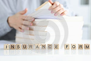 Insurance agent is looking for client insurance form closeup