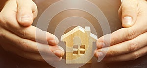 Insurance agent protects the house with a gesture of protection. The concept of property insurance protection and housing.