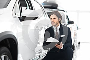 Insurance Agent Sitting Taking Notes About Used Car