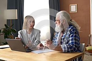 Insurance agent talking to senior man at home