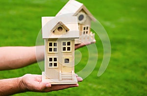Insurance agent with toy house. The concept of property insurance protection and housing. Security and safety in the