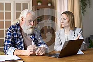 Insurance agent using laptop during meeting