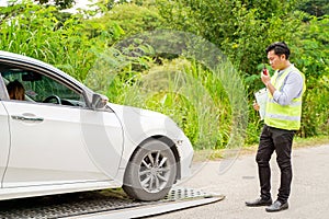 An insurance agent is using a radio communication to talk about a car crash., Accident, crash or collision of auto car