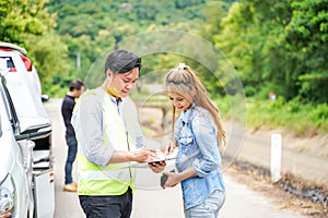 The insurance agent writing the details on the claim report form after the accident.