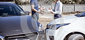Insurance agents inspect for damage to cars that collide on the road to claim compensation from driving accidents