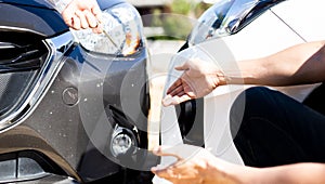 Insurance agents inspect for damage to cars that collide on the road to claim compensation from driving accidents