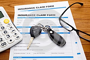 Insurance claim concept with car key and calculator