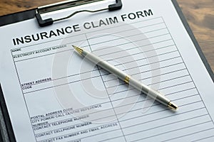 Insurance claim form and a pen