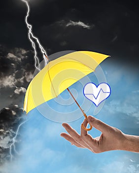 Insurance concept. Man covering heart illustration with yellow umbrella during storm