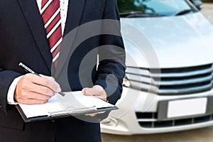 An insurance expert employee working with a car at the outdoor