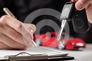 Insurance officers hand over the car keys after the tenant