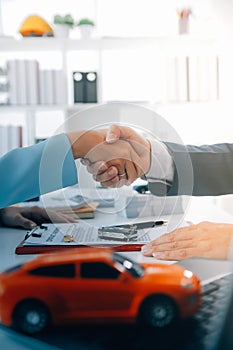 Insurance officers hand over the car keys after the tenant. have signed an auto insurance document or a lease or agreement