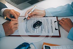 Insurance officers hand over the car keys after the tenant. have signed an auto insurance document or a lease or agreement