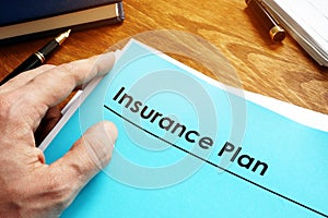 Insurance Plan policy papers on desk.