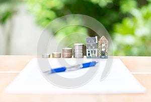 Insurance real estate  form agreement, buy and sell home model on out of focus background photo