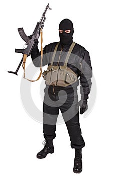 Insurgent in black uniform and mask with kalashnikov