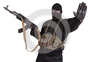 Insurgent in black uniform and mask with kalashnikov