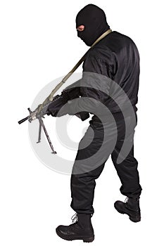 Insurgent in black uniform and mask with machine gun