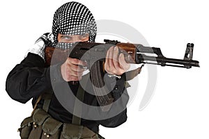 Insurgent dressed in black uniform and black and white shemagh with AK 47 rifle