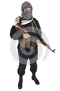 Insurgent dressed in black uniform and black and white shemagh with AK 47 rifle